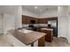 Modern kitchen with dark cabinetry, a center island, and stainless steel appliances at 19942 N 108Th Ave, Peoria, AZ 85373