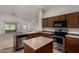 Well-equipped kitchen with stainless steel appliances and a functional center island at 19942 N 108Th Ave, Peoria, AZ 85373