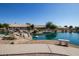 Beautiful lake view with rock features, bench, and well-maintained landscaping creating a serene setting at 19942 N 108Th Ave, Peoria, AZ 85373