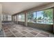 Enclosed patio features checkered carpet and view of the lake with trees at 19942 N 108Th Ave, Peoria, AZ 85373