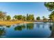 Scenic pond with a fountain surrounded by green space and trees creating a tranquil environment at 19942 N 108Th Ave, Peoria, AZ 85373