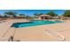 Large community pool area with clear blue water, lounge chairs, and shaded seating at 19942 N 108Th Ave, Peoria, AZ 85373