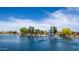 Stunning lake with a beautiful water fountain, creating a focal point within the serene waterfront community at 19942 N 108Th Ave, Peoria, AZ 85373