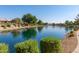 Beautiful view of the lake featuring lush landscaping and calm waters, creating a serene and inviting atmosphere at 19942 N 108Th Ave, Peoria, AZ 85373