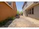 Backyard showcasing desert landscaping, a small patio, and neighboring homes at 20045 N 49Th Dr, Glendale, AZ 85308