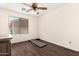 Bedroom featuring wood floors, ceiling fan and window with blinds at 20045 N 49Th Dr, Glendale, AZ 85308