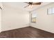 Empty bedroom with hardwood floors, a ceiling fan and a view of the outdoors at 20045 N 49Th Dr, Glendale, AZ 85308