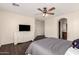 Comfortable bedroom with hardwood floors, ceiling fan, TV and attached bathroom at 20045 N 49Th Dr, Glendale, AZ 85308