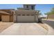 Garage with automatic door, desert landscaping and driveway at 20045 N 49Th Dr, Glendale, AZ 85308