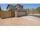 Garage with automatic door, desert landscaping, driveway and gated access at 20045 N 49Th Dr, Glendale, AZ 85308