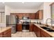 Modern kitchen showcasing stainless steel appliances, granite countertops, and dark wood cabinetry at 20045 N 49Th Dr, Glendale, AZ 85308