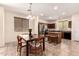 Open kitchen and dining area featuring stainless steel appliances, dark wood cabinets, and an island at 20045 N 49Th Dr, Glendale, AZ 85308