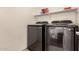 The laundry room features a modern washer and dryer set with a shelf above at 20045 N 49Th Dr, Glendale, AZ 85308
