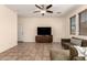 Comfortable living room with a sectional sofa, modern media center, and large windows for natural light at 20045 N 49Th Dr, Glendale, AZ 85308