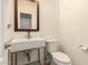 Modern powder room featuring a floating sink, elegant mirror, and contemporary fixtures at 20045 N 49Th Dr, Glendale, AZ 85308