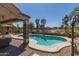 Backyard pool with a well-designed patio, covered seating area, and a view of the surrounding neighborhood at 20420 N 93Rd Dr, Peoria, AZ 85382