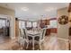 Dining room with wood-look floors, a ceiling fan, and views of the kitchen and living room at 20420 N 93Rd Dr, Peoria, AZ 85382