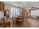 Cozy dining room with rustic wood table, chairs, and plantation shutters for natural light at 20420 N 93Rd Dr, Peoria, AZ 85382