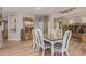 Dining room with table and chairs, with views to a living room and bar area, and wood-look flooring at 20420 N 93Rd Dr, Peoria, AZ 85382