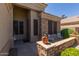 Charming front porch with comfortable seating area framed by tasteful brickwork and lush landscaping at 20420 N 93Rd Dr, Peoria, AZ 85382