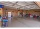 Spacious garage with epoxy flooring, ample storage, and utility connections for various needs at 20420 N 93Rd Dr, Peoria, AZ 85382