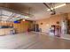 Well-organized garage with storage solutions and appliances, offering functional space at 20420 N 93Rd Dr, Peoria, AZ 85382