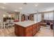 Expansive kitchen island with seating, storage, and a view to the dining and living areas at 20420 N 93Rd Dr, Peoria, AZ 85382
