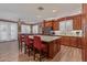 Spacious kitchen with granite countertops, island with seating and stainless steel appliances at 20420 N 93Rd Dr, Peoria, AZ 85382