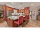 Well-lit kitchen features an island with seating, stainless steel appliances and ample cabinetry at 20420 N 93Rd Dr, Peoria, AZ 85382