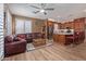 Open concept living space with a living room and kitchen, tile flooring, and a ceiling fan at 20420 N 93Rd Dr, Peoria, AZ 85382