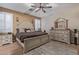 Main bedroom with neutral tones, elegant furniture, and plantation shutters for soft, natural lighting at 20420 N 93Rd Dr, Peoria, AZ 85382