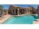 Inviting backyard pool features a basketball hoop, outdoor seating, and a view of the covered patio at 20420 N 93Rd Dr, Peoria, AZ 85382