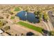 Scenic aerial image of a golf course community complete with a pond and manicured green space in Arizona at 20506 N 271St Ave, Buckeye, AZ 85396