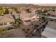 An aerial view showing a desert home with covered patio and landscaped backyard, featuring sunset views at 20506 N 271St Ave, Buckeye, AZ 85396