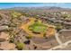 Stunning aerial view of a golf course community nestled in the Arizona desert, offering beautiful mountain views at 20506 N 271St Ave, Buckeye, AZ 85396