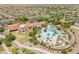 Resort style living at it's finest; a community pool with palm trees, green grass, and resort style amenities at 20506 N 271St Ave, Buckeye, AZ 85396