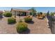 Expansive backyard with desert landscaping, a covered patio, and an outdoor dining set, ideal for relaxing outdoors at 20506 N 271St Ave, Buckeye, AZ 85396