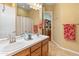 A bathroom with double sinks and a large mirror at 20506 N 271St Ave, Buckeye, AZ 85396