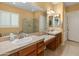 A bathroom with double sinks, framed mirrors, and a separate shower at 20506 N 271St Ave, Buckeye, AZ 85396