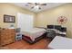 A bedroom with hardwood floors, plantation shutters, and a ceiling fan at 20506 N 271St Ave, Buckeye, AZ 85396