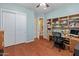 A bedroom with hardwood floors and a closet with double doors at 20506 N 271St Ave, Buckeye, AZ 85396