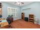 A clean bedroom with hardwood floors, plantation shutters, and a ceiling fan at 20506 N 271St Ave, Buckeye, AZ 85396