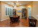 The dining room features hardwood floors, plantation shutters and a round wood dining table at 20506 N 271St Ave, Buckeye, AZ 85396