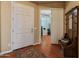 Inviting foyer with hardwood floors, a white front door, and view into a home office at 20506 N 271St Ave, Buckeye, AZ 85396