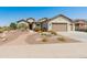 Attractive single-story home with desert landscaping, paved walkway, and a two-car garage at 20506 N 271St Ave, Buckeye, AZ 85396