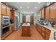 Bright kitchen featuring custom cabinetry, stainless appliances, a breakfast area, and a functional center island at 20506 N 271St Ave, Buckeye, AZ 85396
