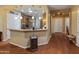 Open-concept kitchen with wood cabinetry, granite countertops, and modern appliances at 20506 N 271St Ave, Buckeye, AZ 85396