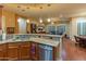 Kitchen with granite countertops, stainless appliances, and open floor plan to living area at 20506 N 271St Ave, Buckeye, AZ 85396