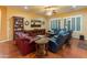 Bright living room featuring hardwood floors, a built-in bookshelf and multiple seating areas at 20506 N 271St Ave, Buckeye, AZ 85396