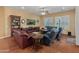 Bright living room featuring hardwood floors, a built-in bookshelf and multiple seating areas at 20506 N 271St Ave, Buckeye, AZ 85396